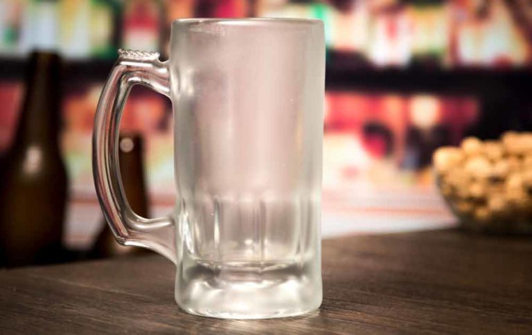 How to chill a beer glass. An empty beer mug with a frosty film after being removed from the freezer.